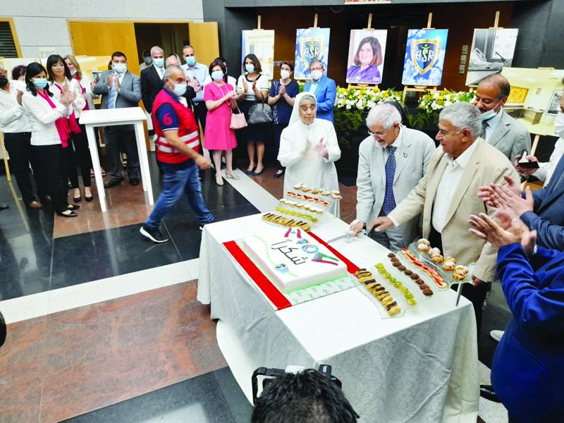 BEIRUT: Dr Hilal Al-Sayer (left) and Tareq Al-Mutawa cut a cake during a ceremony to celebrate the reopening of wards at Wardieh Hospital in Beirut. - KUNA photosnn