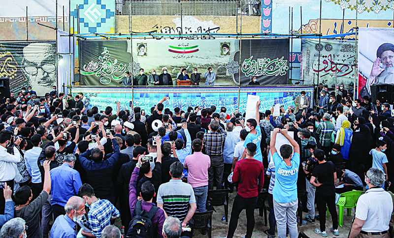 ESLAMSHAHR, Iran: Iranian presidential candidate Ebrahim Raisi (podium center) speaks during an election campaign rally in the city of Eslamshahr, about 25 kilometers south of the centry of the capital Tehran.-AFP n