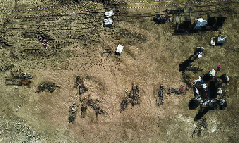 BADUSH, Iraq : This aerial view , shows human remains, reportedly of victims of the 2014 Badush prison massacre committed by the Islamic State (IS) group, after being unearthed from a mass grave in the northern Iraqi village of Badush, northwest of the city of Mosul.-AFP n