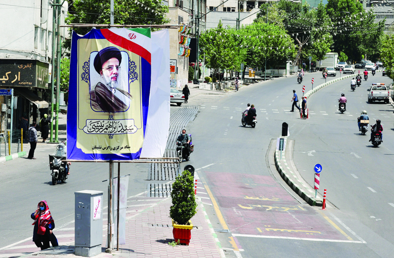 TEHRAN: A banner of ultraconservative Iranian cleric and presidential candidate Ebrahim Raisi, is pictured in Tehran, yesterday on the eve of the Islamic republic's presidential election. - AFPnn