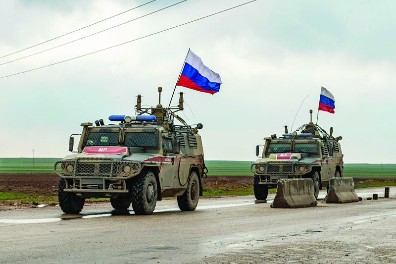 HASAKEH: File photo shows Russian military police vehicles patrol the M4 highway in the northeastern Syrian Hasakeh province. UN and a handful of countries pressured Russia to continue allowing authorization of the only border crossing through which humanitarian aid reaches Syria's insurgent. – AFPnnn n