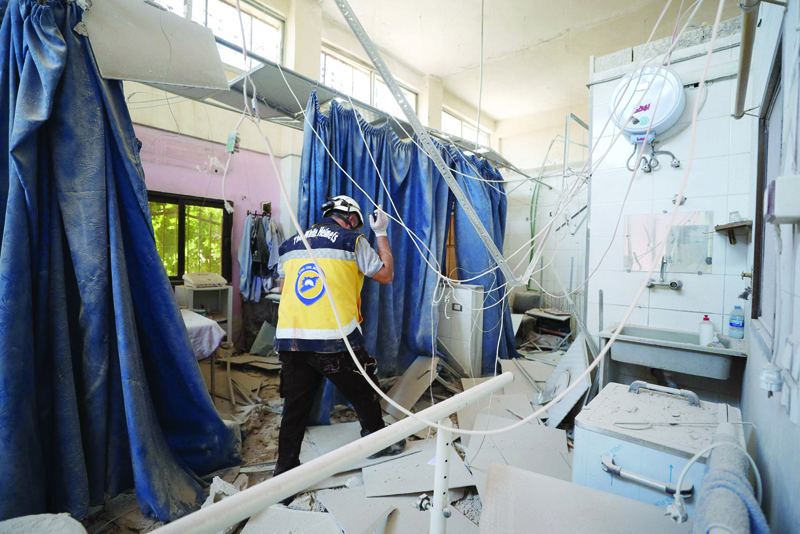 AFRIN, Syria: A member of Syria's Civil Defense service (White Helmets) inspects the damage yesterday in one of the rooms of the Al-Shifaa hospital, a day after it was hit by artillery shells in the rebel-held northern Syrian city of Afrin, reportedly fired by pro-regime forces, killing at least 18 people, and wounding more than 23, according to a war monitor. - AFPnn nn