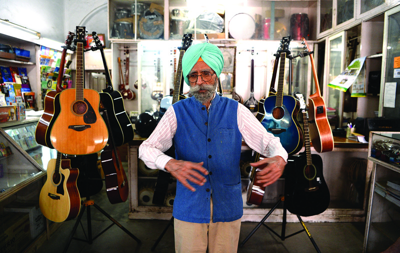 In this file photo taken on June 19, 2018, Ajit Singh, owner of the music shop who fixed John Lennon's guitar and performed at George Harrison's 25th birthday party when the Beatles stayed at an ashram in nearby Rishikesh 50 years ago in 1968, poses for a picture in Dehradun. - AFP n