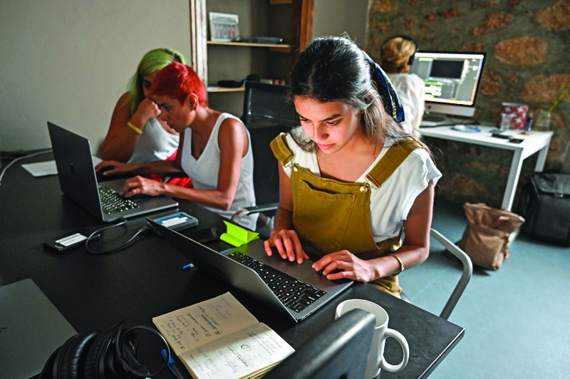 ATHENS: Adriana Theohari and women participating in a project on gender equality edit short films and podcasts in the office of an organization. — AFPn