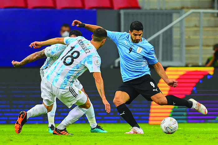 BRASILIA: Uruguay’s Luis Suarez (right) is challenged by Argentina’s Guido Rodriguez during their Conmebol Copa America 2021 football tournament group phase match at the Mane Garrincha Stadium in Brasilia, on Friday. — AFP