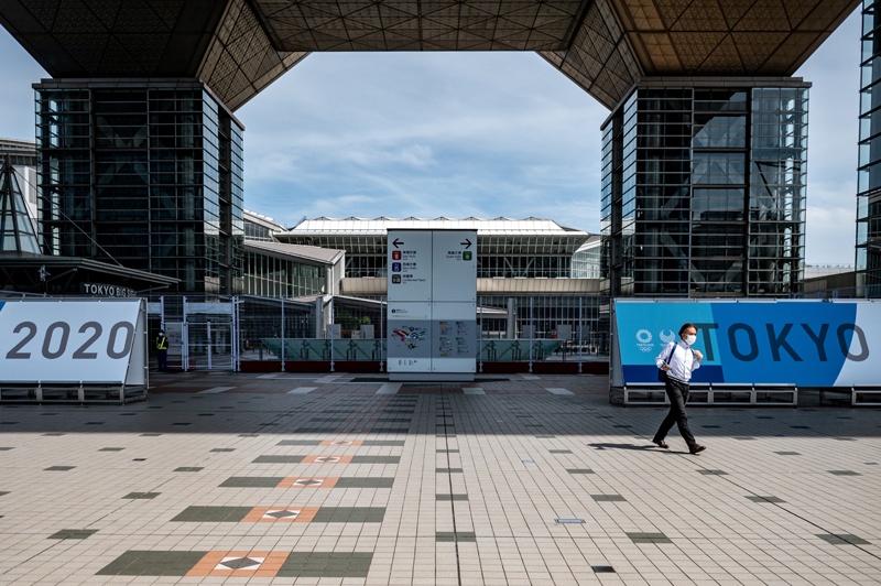 TOKYO: A man walks out from the entrance of the Tokyo International Exhibition Centre, also known as Tokyo Big Sight, where the International Broadcast Centre and Main Press Centre for the Tokyo 2020 Olympic and Paralympic Games are located, in Tokyo yesterday. – AFPn