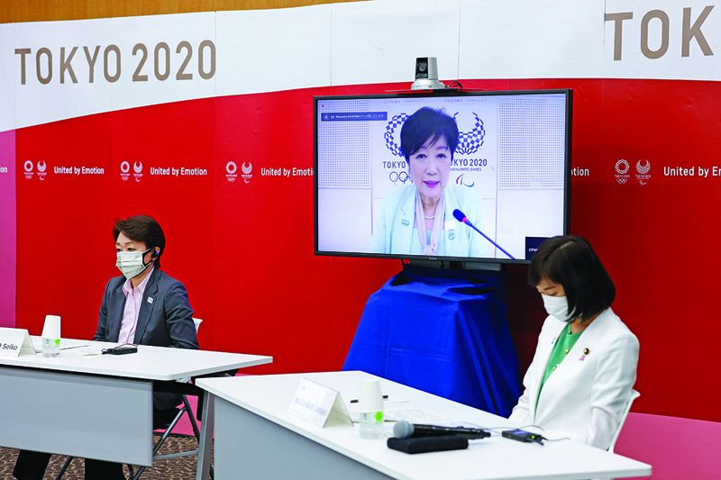 TOKYO: (From left) Seiko Hashimoto, President of Tokyo 2020, Tokyo Governor Yuriko Koike (on screen) and Tamayo Marukawa, Minister for the Tokyo Olympic and Paralympic Games, speak during a five-party meeting at Harumi Island Triton Square Tower Y in Tokyo yesterday. – AFPn
