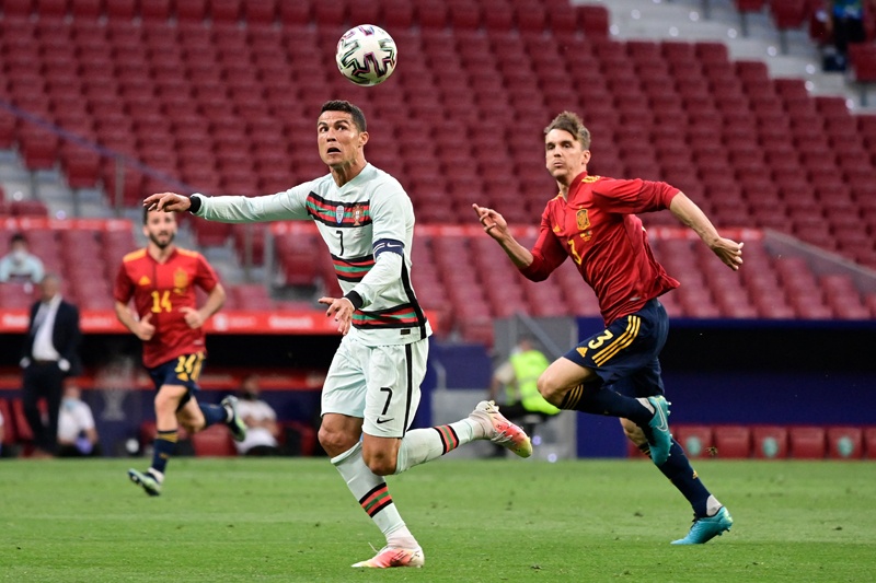 MADRID: Portugal's forward Cristiano Ronaldo (left) heads the ball next to Spain's defender Diego Llorente during the international friendly football match between Spain and Portugal at the Wanda Metropolitano stadium in Madrid in preparation for the UEFA European Championships, on Friday. – AFPnn