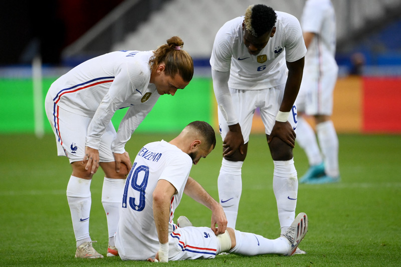 SAINT-DENIS: France's forward Antoine Griezmann (left) and France's midfielder Paul Pogba (right) talk to France's forward Karim Benzema, injured, during the friendly football match France vs Bulgaria ahead of the Euro 2020 tournament, at Stade De France in Saint-Denis, on the outskirts of Paris on Tuesday. – AFPnn