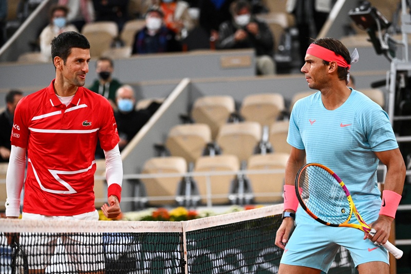 PARIS: In this file photo taken on October 11, 2020 Spain's Rafael Nadal (right) and Serbia's Novak Djokovic talk prior to their men's final tennis match at the Philippe Chatrier court at The Roland Garros 2020 French Open tennis tournament in Paris. – AFPn