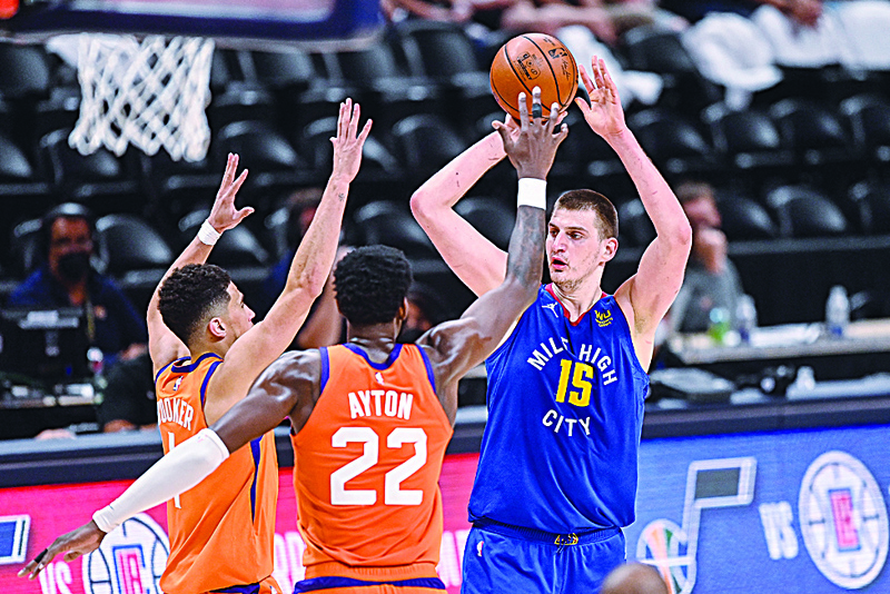 DENVER: Nikola Jokic #15 of the Denver Nuggets looks for a shot against the Phoenix Suns in Game Three of the Western Conference second-round playoff series at Ball Arena on Friday. - AFP n