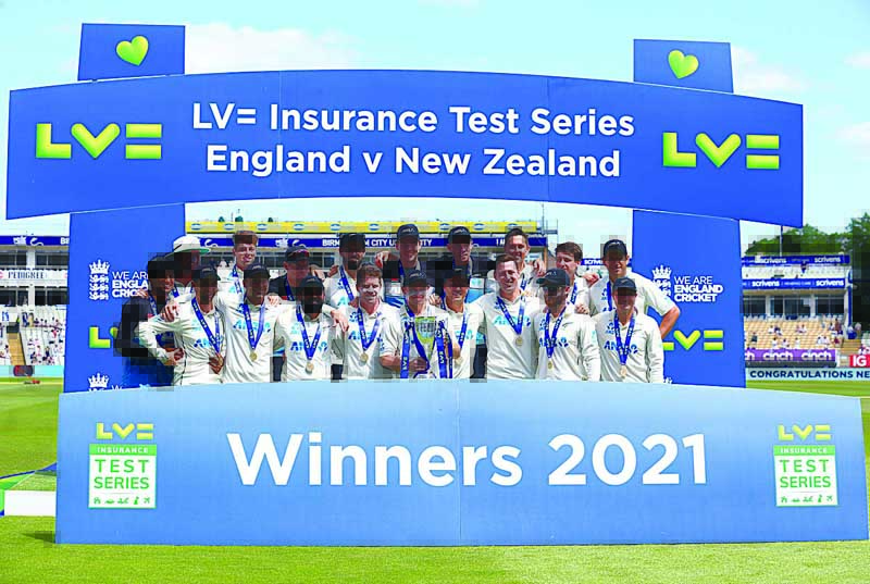 BIRMINGHAM: New Zealand's players celebrate with the trophy for winning the series after clinching victory on the fourth day of the second Test cricket match between England and New Zealand at Edgbaston Cricket Ground yesterday. - AFP n