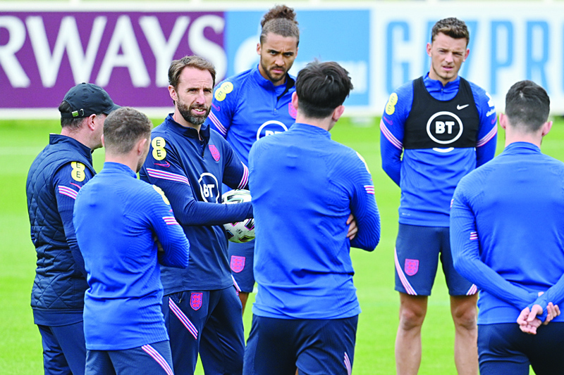 BURTON-ON-TRENT: England's coach Gareth Southgate (third left) leads a training session of his team at St George's Park in Burton-on-Trent yesterday. - AFPnn