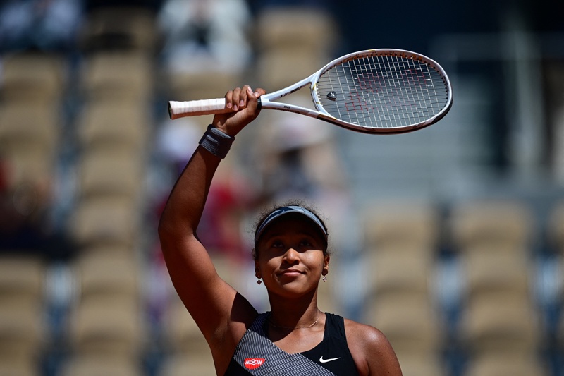 PARIS: Japan's Naomi Osaka celebrates after winning against Romania's Patricia Maria Tig during their women's singles first round tennis match on Day 1 of The Roland Garros 2021 French Open tennis tournament in Paris on Sunday. – AFPn