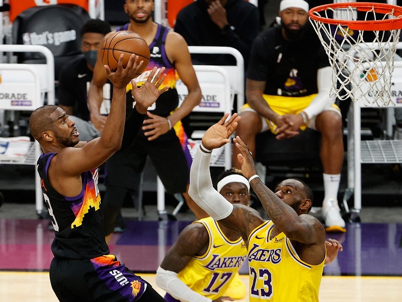 PHOENIX: Chris Paul #3 of the Phoenix Suns attempts a shot over LeBron James #23 of the Los Angeles Lakers during the second half in Game Five of the Western Conference first-round playoff series at Phoenix Suns Arena on Tuesday in Phoenix, Arizona. – AFPn