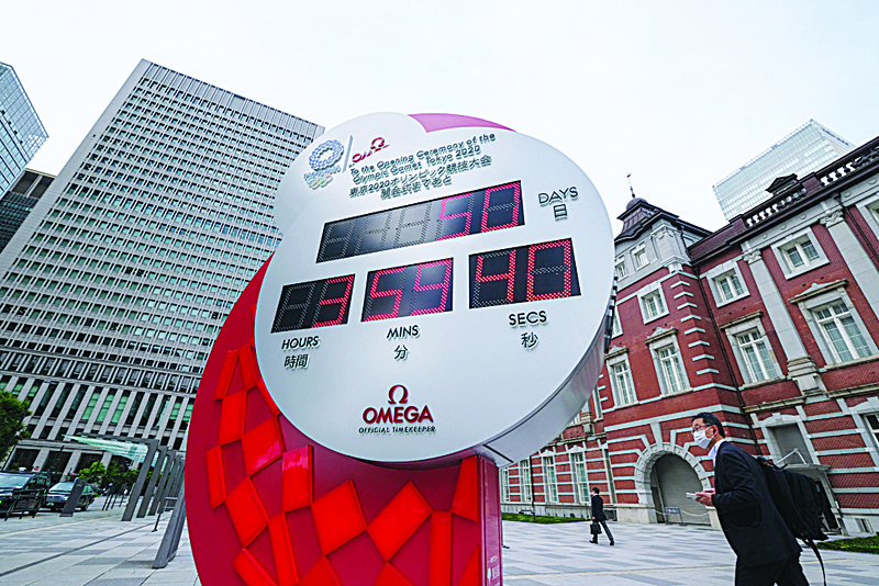 TOKYO: The countdown clock for the Tokyo 2020 Olympic Games is displayed with 50 days before the opening ceremony outside a Tokyo station yesterday. - AFP n