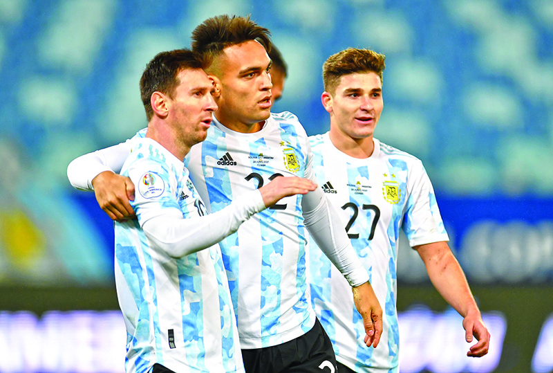 CUIABA: Argentina's Lautaro Martinez celebrates with Lionel Messi after scoring against Bolivia during the Conmebol Copa America 2021 football tournament group phase match, at the Arena Pantanal Stadium in Cuiaba, Brazil, on Monday. - AFPnn