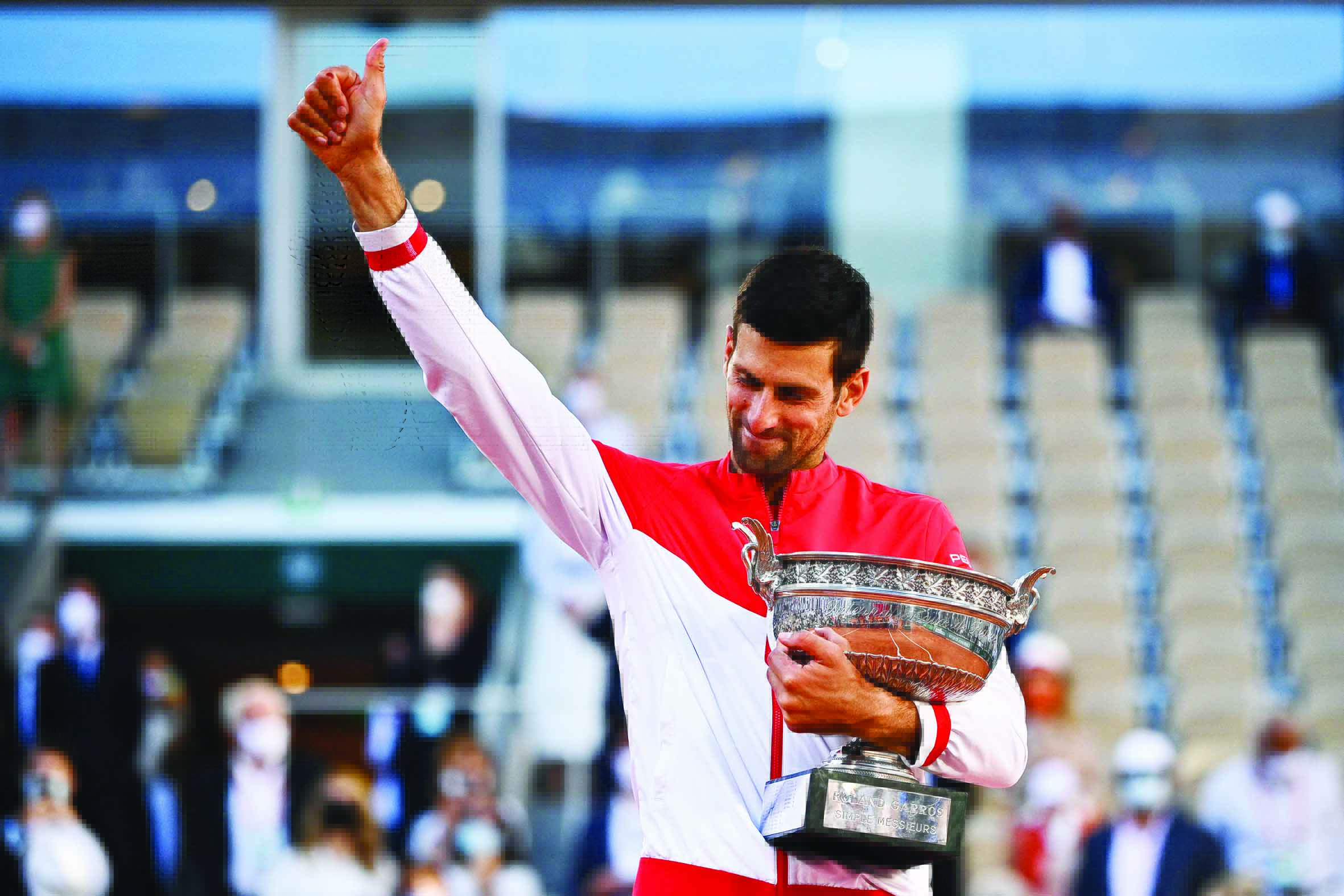 PARIS: Serbia's Novak Djokovic poses with The Mousquetaires Cup (The Musketeers) after winning against Greece's Stefanos Tsitsipas at the end of their men's final match on Day 15 of The Roland Garros 2021 French Open tennis tournament yesterday. - AFP n