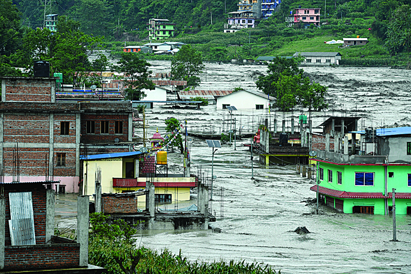 SINHUPALCHOK: This general view shows houses submerged in flood waters in Sindhupalchok, some 70 km northeast of Kathmandu, after heavy monsoon rains caused the overflowing of the Melamchi River. - AFPnnn