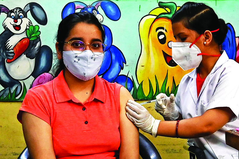 NEW DELHI: A health worker inoculates a woman with a jab of Covishield's COVID-19 Coronavirus vaccine at a vaccination Centre in New Delhi yesterday. – AFPnn