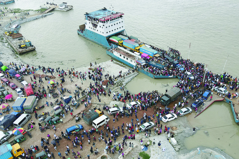 MUNSHIGANJ, Bangladesh: People board a ferry as authorities ordered a new lockdown to contain the spread of the COVID-19 in Munshiganj, yesterday. - AFPn