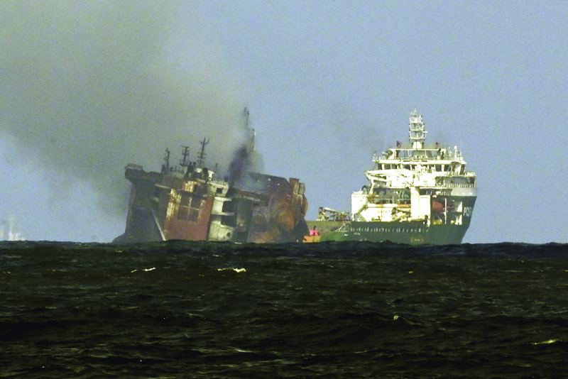 COLOMBO: File photo taken on June 02, 2021 shows a tugboat (R) from the Dutch salvage firm SMIT tows the fire stricken Singapore-registered container ship MV X-Press Pearl away from the coast of Colombo, following Sri Lankan President Gotabaya Rajapaksa's order to move the ship to deeper water. - AFPnnn 