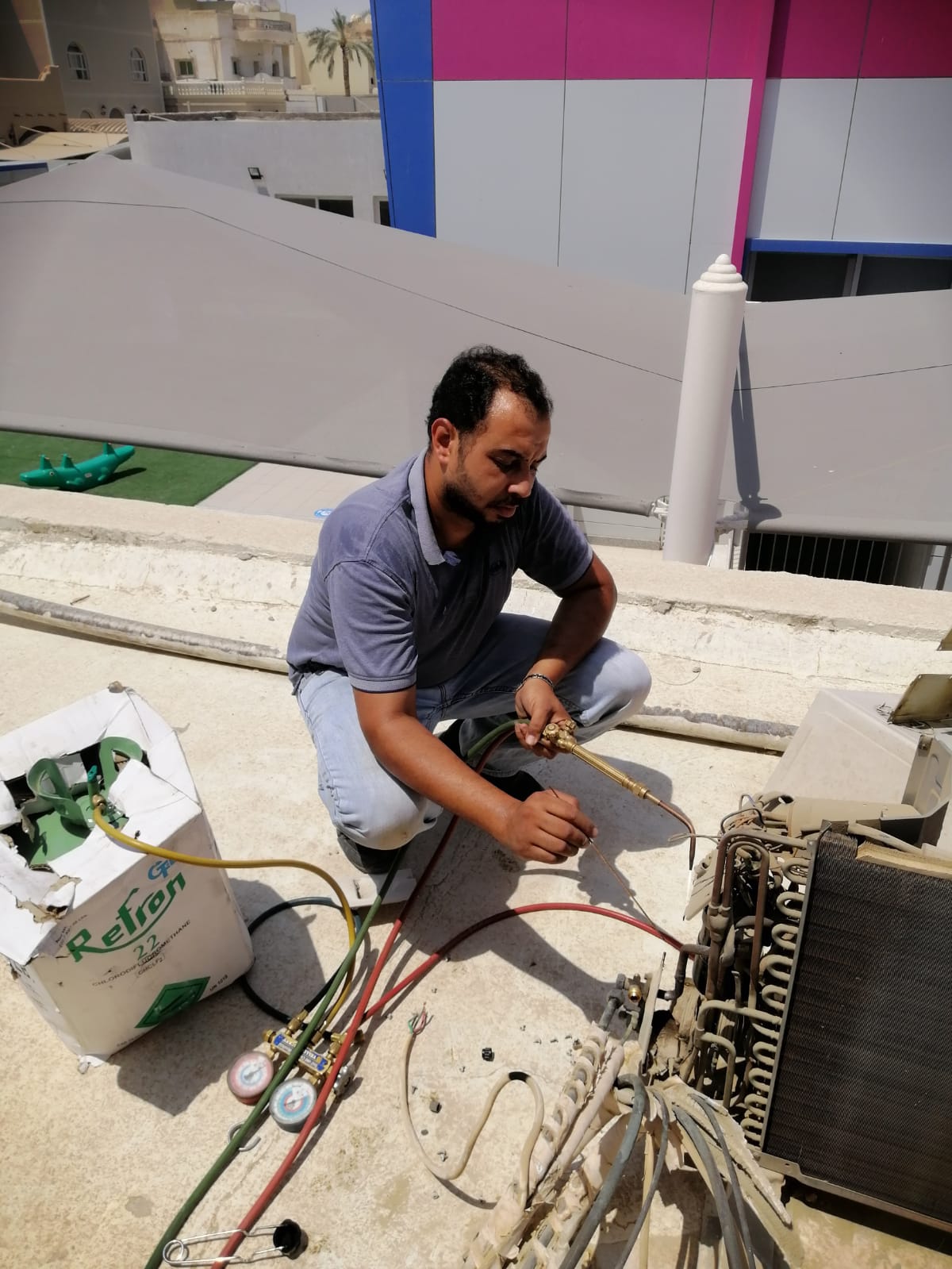 AC technician Ahmad Ali Al-Jihlan services an air conditioner. n