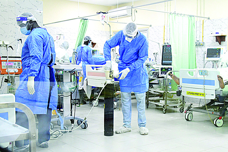 DAKAR: Health workers wearing personal protective gear are seen at the intensive care unit at the Idrissa Pouye de Grand Yoff Hospital, yesterday. - AFPnn