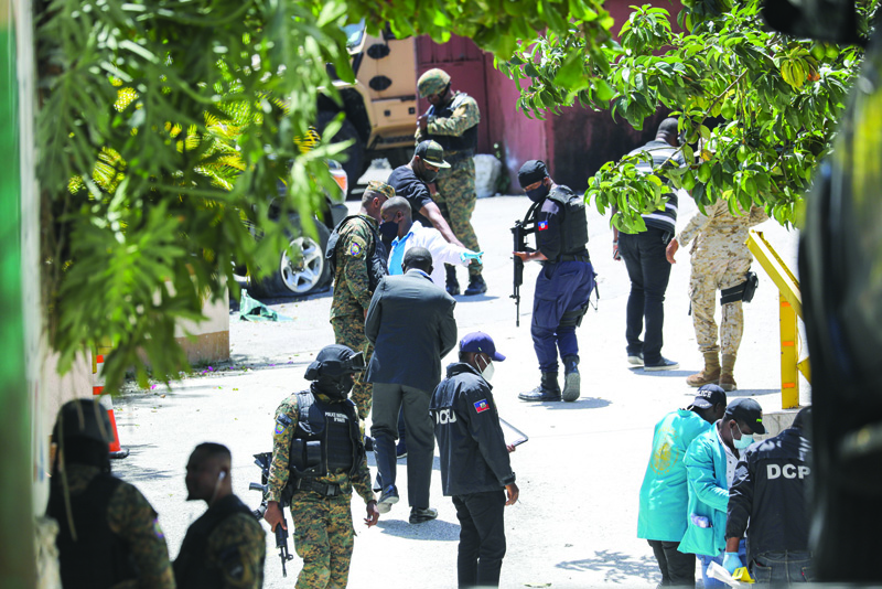 PORT-AU-PRINCE, Haiti: Members of the Haitian police and forensics look for evidence outside of the presidential residence Haiti. - AFP n