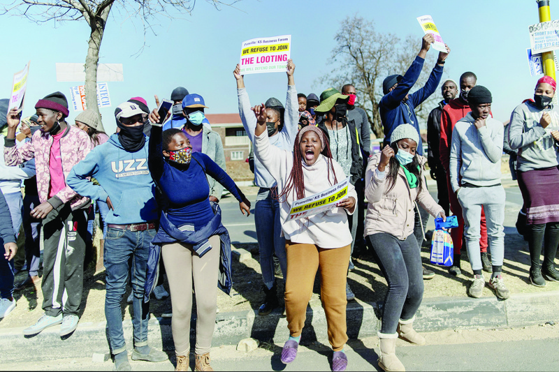 SOWETO: Residents of Soweto shout slogan in front of Maponya Mall in Soweto, yesterday as they protest against the wave of violence and looting that afflicted several South African provinces during the past four days. - AFPnnn