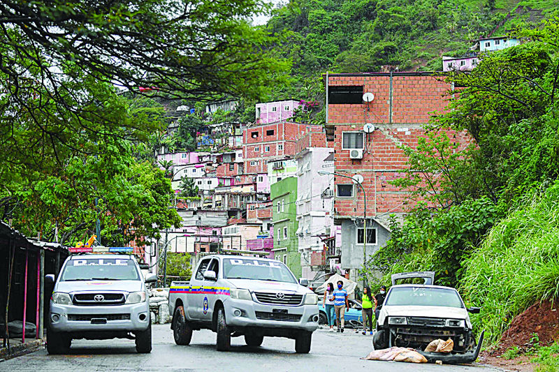 CARACAS: File photo shows Members of the Directorate of Strategic Intelligence (DIE) patrol one of the main streets of the Cota 905 neighborhood after three days of clashes with alleged members of a criminal gang in Caracas. - AFPn