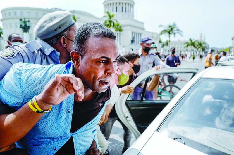 HAVANA: File photo shows a man is arrested during a demonstration against the government of Cuban President Miguel Diaz-Canel in Havana. - AFPn