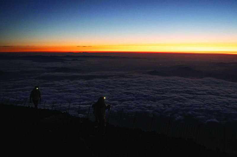 This photo taken on July 19, 2021 shows people hiking up to watch the sunrise from the summit of Mount Fuji, some 70 km west of the capital Tokyo. – AFP photosn