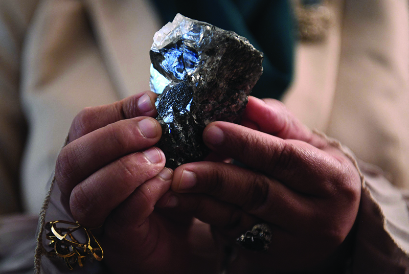 A member of the Botswana cabinet holds a 1,174-carat diamond in Gaborone, Botswana, that the Lucara Botswana found during an eleven day production run in June 2021. -AFP photosn