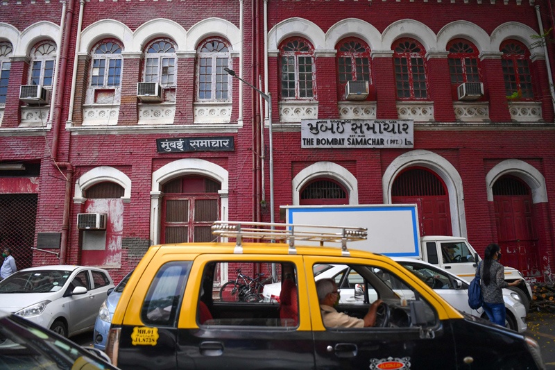 In this photograph a taxi drives past the office building of the Mumbai Samachar newspaper, Asia’s oldest newspaper still in print, in Mumbai. — AFPn