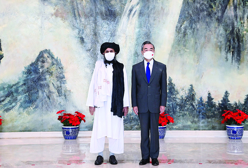 TIANJIN: This photo taken yesterday, and released by China's Xinhua News Agency shows Chinese State Councilor and Foreign Minister Wang Yi (R) meeting with Mullah Abdul Ghani Baradar, political chief of Afghanistan's Taleban, in Tianjin. - AFPn