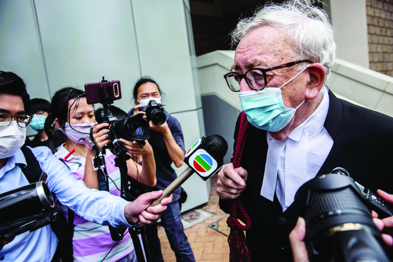 HONG KONG: Senior counsel Clive Grossman (R), who is representing Tong Ying-kit, leaves the High Court in Hong Kong yesterday, after Tong was convicted of terrorism and inciting secession in the first trial conducted under a national security law imposed by China. – AFPnn