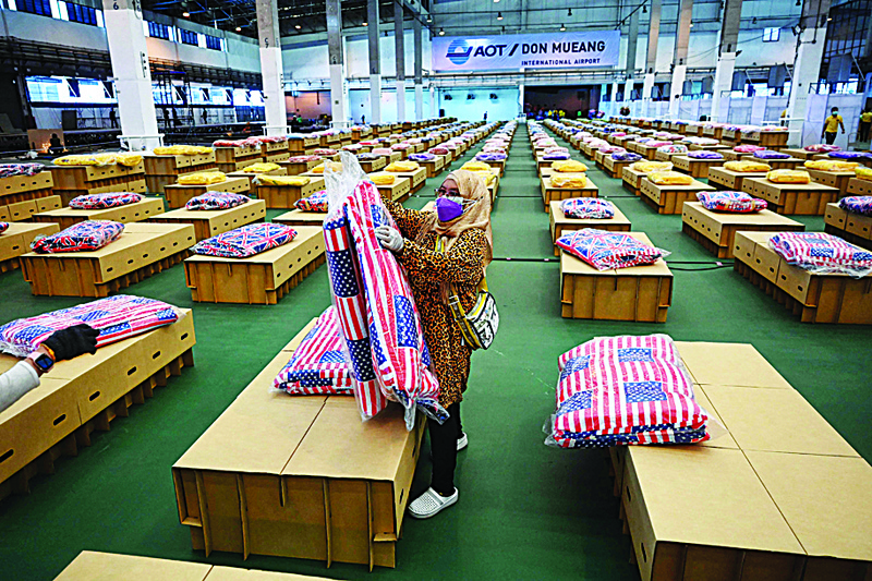 BANGKOK: Workers prepare mattresses and blankets for some 1,800 cardboard beds at a COVID-19 coronavirus field hospital inside a warehouse at the Don Mueang International Airport in Bangkok. - AFPn