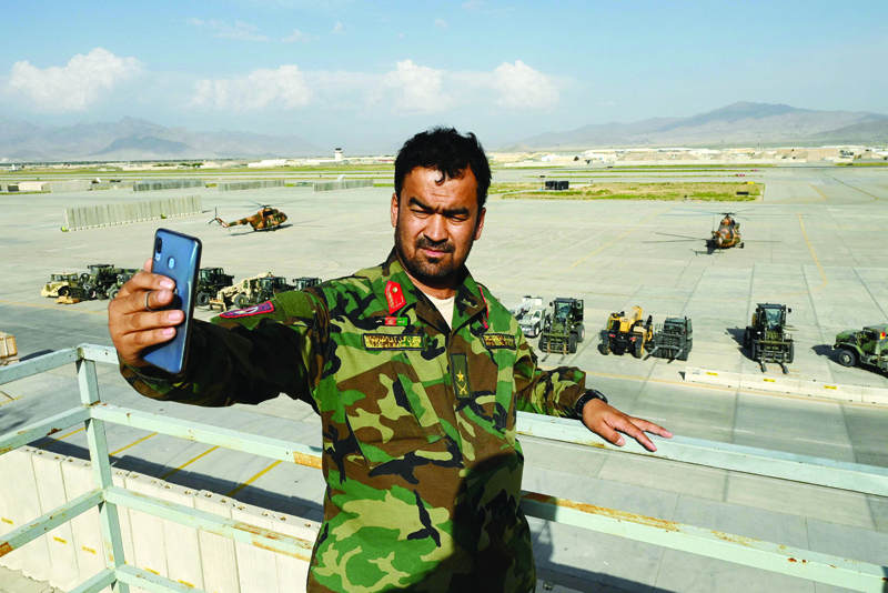 BAGRAM, Afghanistan: An Afghan National Army (ANA) soldier take a selfie with his mobile phone inside the Bagram US air base after all US and NATO troops left, some 70 Kms north of Kabul. - AFP n