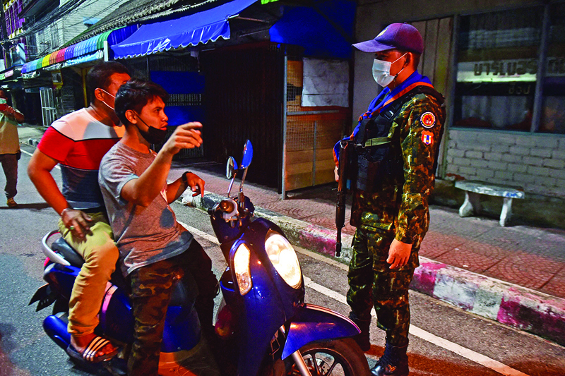 NARATHIWAT: A civilian defence volunteer alerts people to lockdown measures including the curfew introduced to halt the spread of the COVID-19 coronavirus in the southern province of Narathiwat, as Thailand faces a surge in cases of the virus. — AFPnn