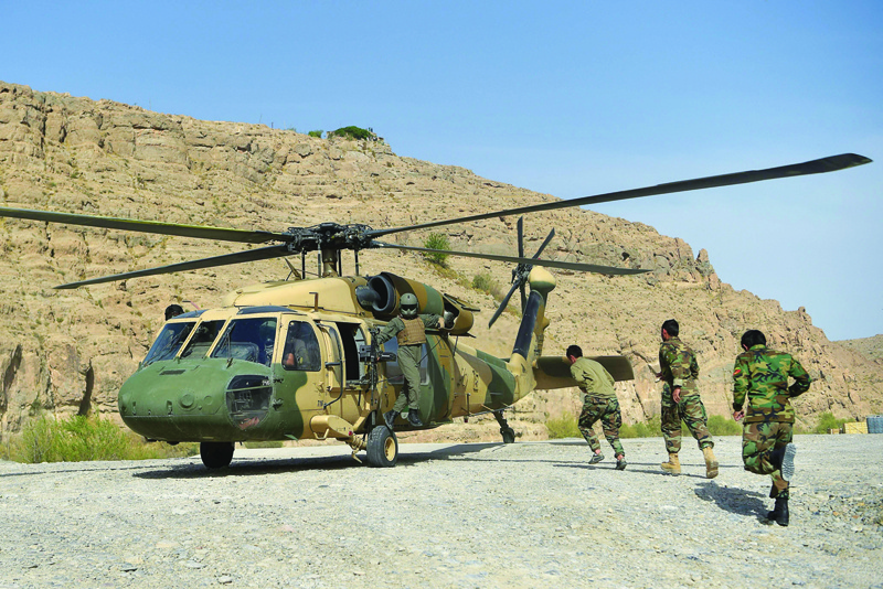 KAJAKI: File photo shows Afghan National Army (ANA) soldiers unload food items and petrol oil from an Afghan Air Force Black Hawk helicopter at the hydroelectric Kajaki Dam in Kajaki. Afghan lawmakers on Friday voiced alarm that their air force was depleted in the face of a Taleban offensive as they asked the United States to finalize assistance ahead of a troop withdrawal. - AFPnn