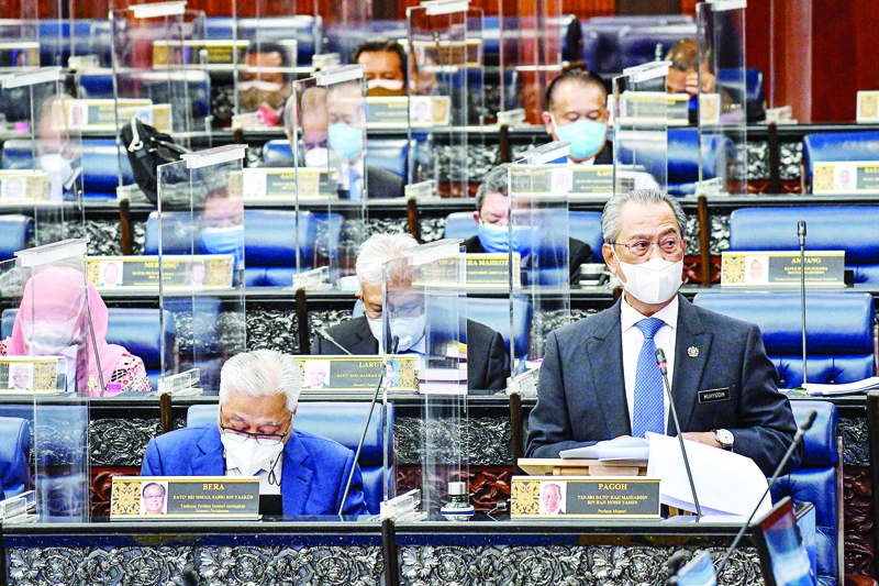KUALA LUMPUR: This handout photo from Malaysia's Department of Information taken and released on July 26, 2021 shows Prime Minister Muhyiddin Yassin delivering his address during a special session of the Dewan Rakyat (House of Representatives) at the Parliament in Kuala Lumpur. - AFPn