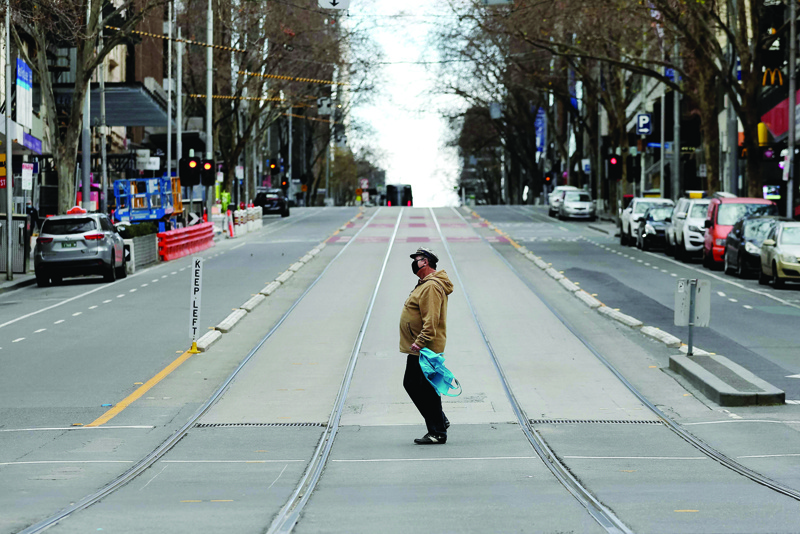 MELBOURNE: A pedestrian walks through the quiet streets of Melbourne yesterday, during the ninth day of the lockdown. - AFPn