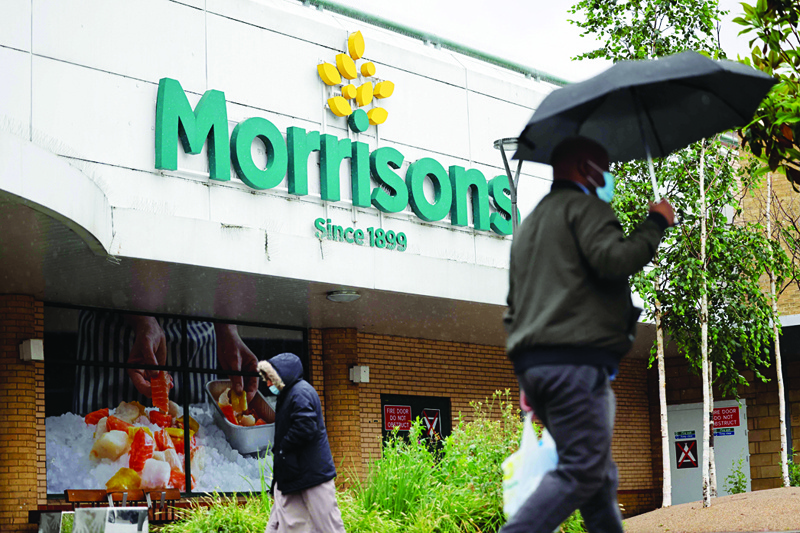 LONDON: File photo shows a man walks past a Morrisons supermarket in Stratford, east London. Britain's fourth biggest supermarket said it had accepted a £6.3-billion ($8.7-billion, 7.3-billion-euro) takeover offer from a consortium of investment groups—AFPnnn