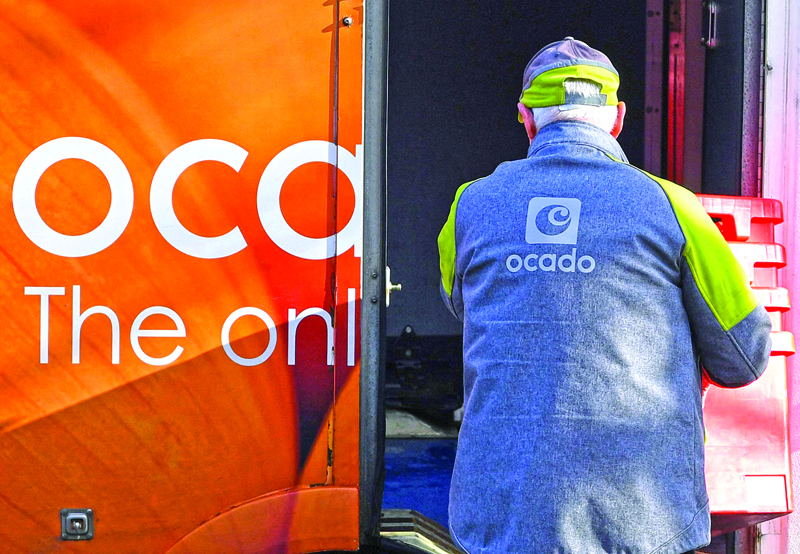 LIVERPOOL: File photo taken on February 10, 2019 a delivery driver returns empty crates to his Ocado delivery van after supplying a residential address near Liverpool in north west England. – AFPnn