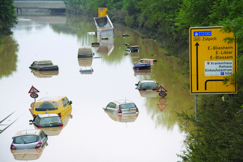 ERFTSTADT: Submerged cars and other vehicles are seen on the federal highway B265 in Erftstadt, western Germany, yesterday, after heavy rains hit parts of the country, causing widespread flooding and major damage. - AFPn