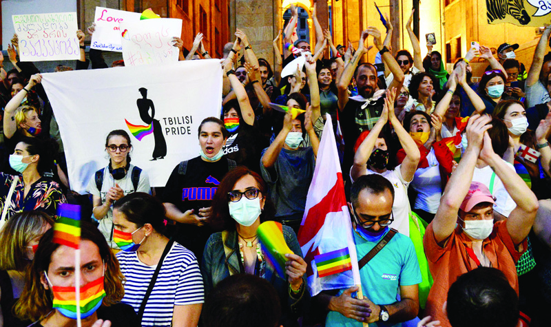 TBILISI: Participants hold rainbow flags during a rally in support of those who were injured during the July 5 protests, when a pride march was disrupted by members of violent groups, in Tbilisi. Thousands rallied in the Georgian capital Tbilisi to denounce attacks targeting LGBTQ community and journalists that shocked the nation. - AFPn