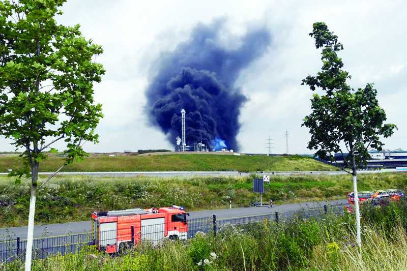 LEVERKUSEN: Fire engines are seen as smoke rises from a landfill and waste incineration area at the Chempark industrial park run by operator Currenta following an explosion in Leverkusen's Buerrig district, western Germany, yesterday. - AFPn