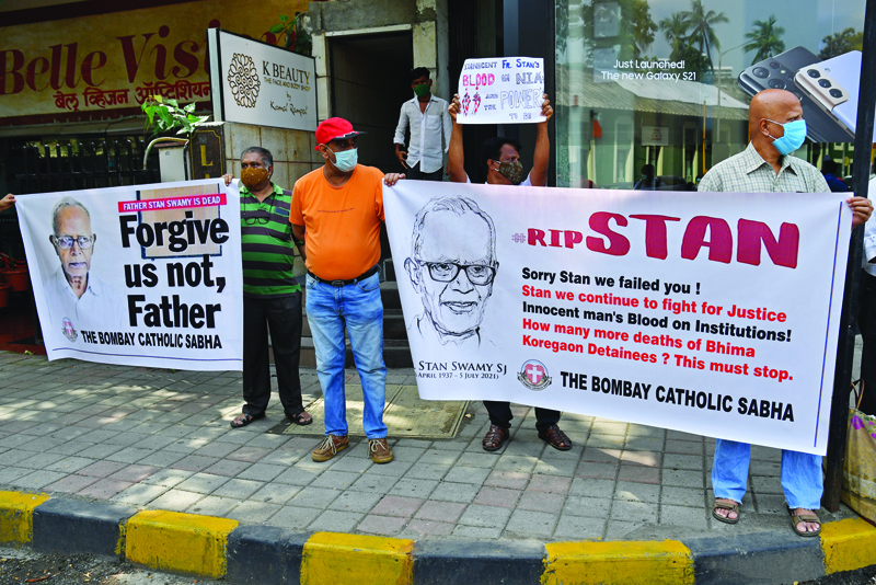 MUMBAI: People hold posters outside the church holding memorial mass for the Indian rights activist and Jesuit priest Father Stan Swamy, in Mumbai yesterday. - AFPn