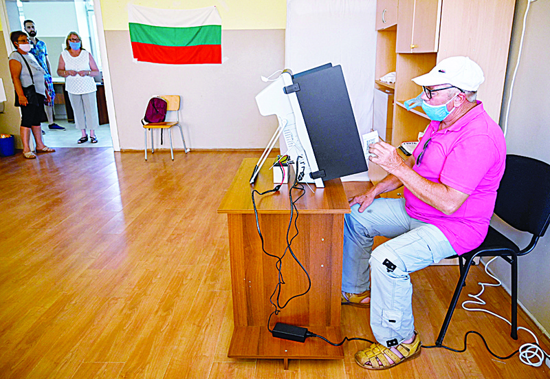 SOFIA: A man casts his ballot at a polling station during the country's parliamentary election in Sofia. - AFPnnn
